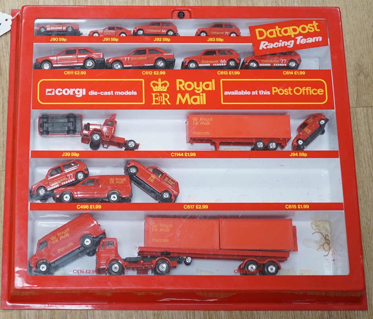 Sixty-six 1980's Corgi Toys Royal Mail vehicles, all boxed or packeted, together with an original ‘point of sale’ Post Office display cabinet for this series of vehicles containing unboxed display examples